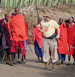 Robert Wilson jumping with Masai warriors in Africa