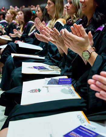 students clapping in audience at spring convocation 2017