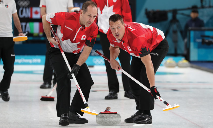 Canadian curlers Brent Laing, left, and Ben Hebert in action  during the Winter Olympic Games. 