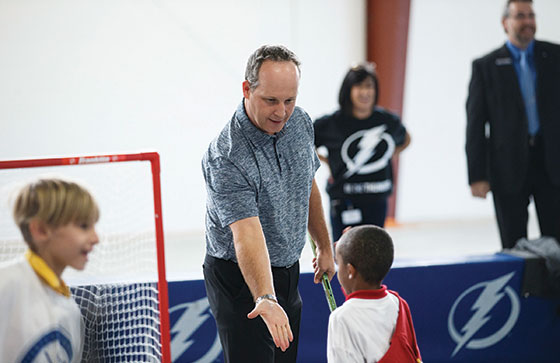Steve Griggs plays street hockey with kids