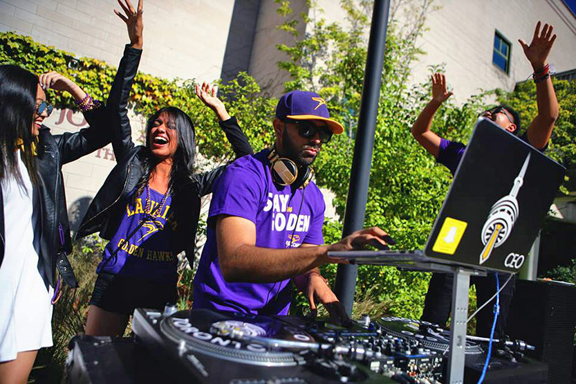 DJ Junaid Ali spins music while onlookers dance in the quad at Waterloo campus
