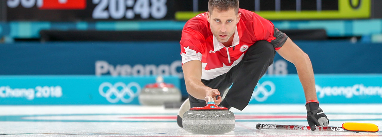 John Morris focuses on his curling rock at the 2018 Winter Olympics.